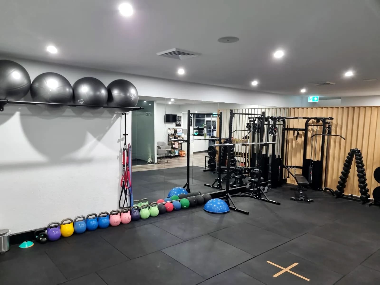 Gym at Concord West with exercise balls, kettlebells and a cable machine