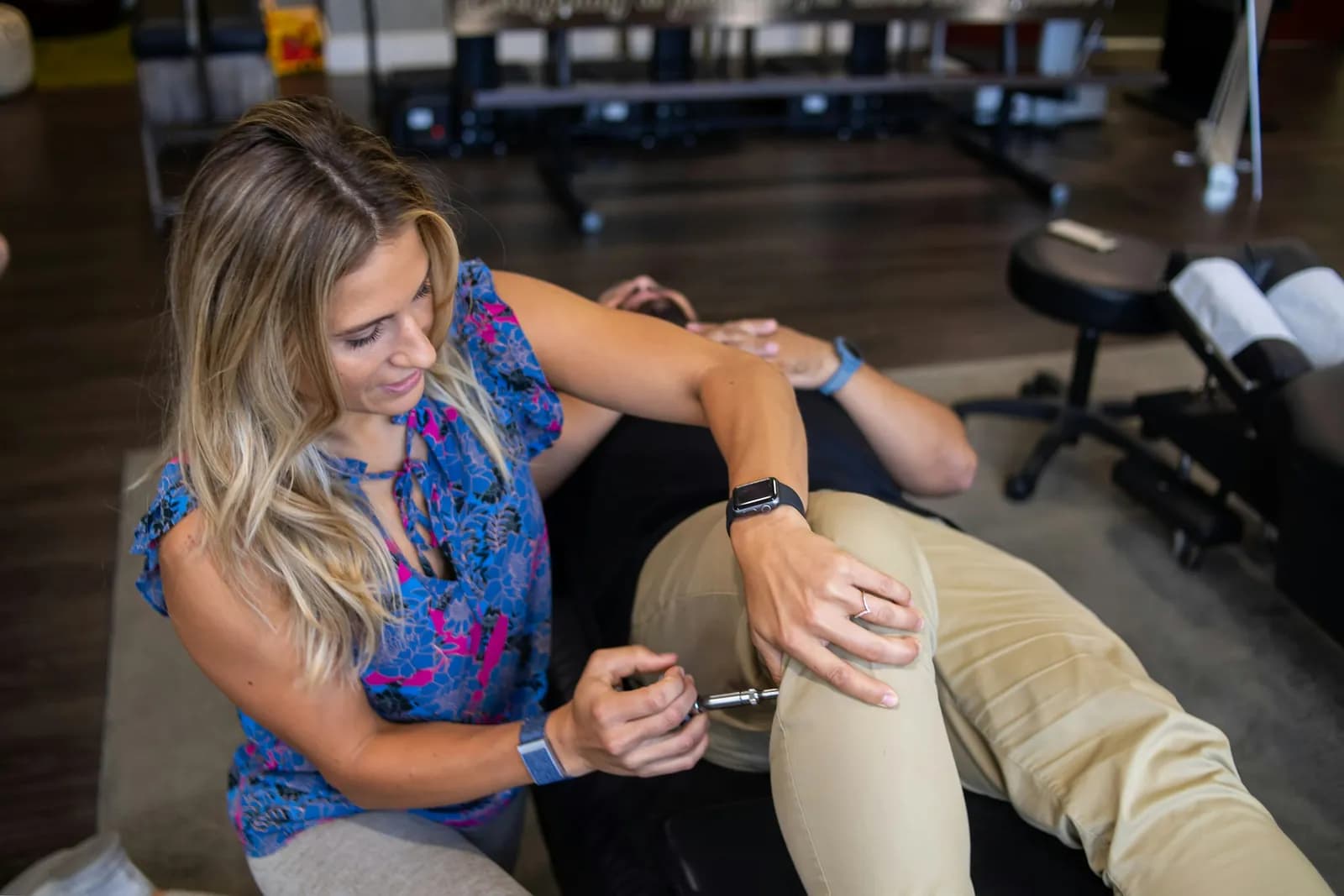 Physiotherapist working on a patient's knee in a clinic